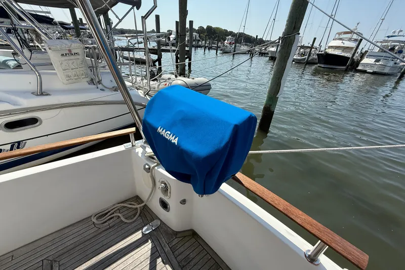 Slide: The Image of Beneteau Swift Trawler 42, 2007 model, docked with Magma grill cover, marina view. - 16