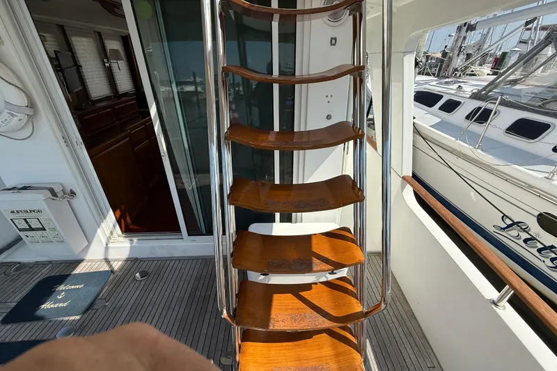 Slide: The Image of Wooden steps on a 2007 Beneteau Swift Trawler 42, leading to the upper deck. - 19
