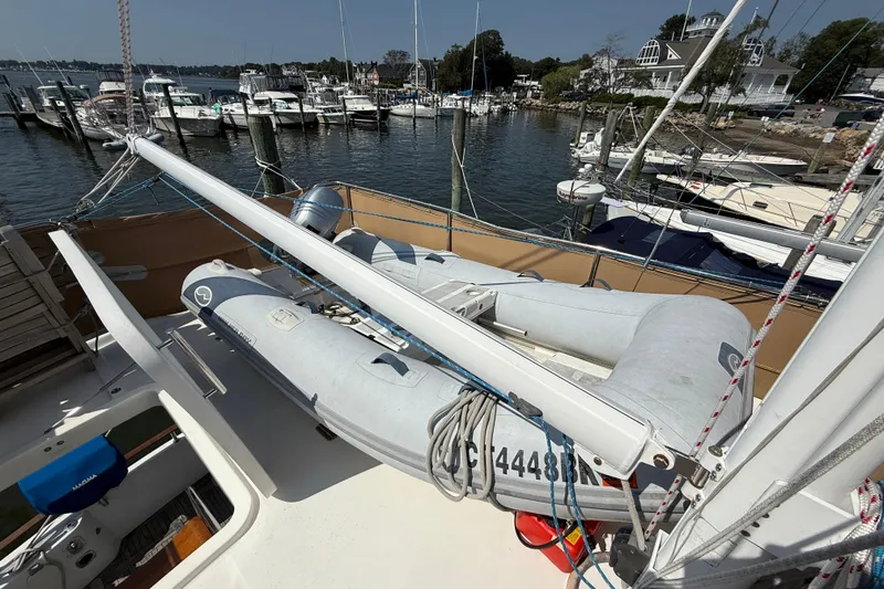 Slide: The Image of 2007 Beneteau Swift Trawler 42 with dinghy on deck, docked at marina. - 20
