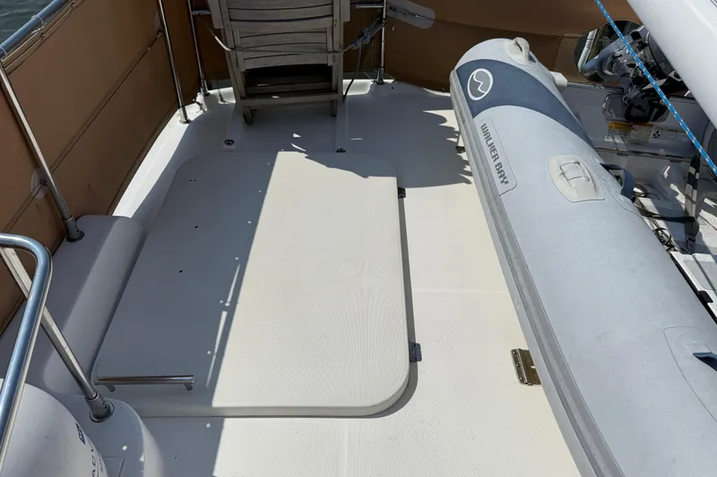 Slide: The Image of Deck of 2007 Beneteau Swift Trawler 42 with inflatable boat and chair. - 23
