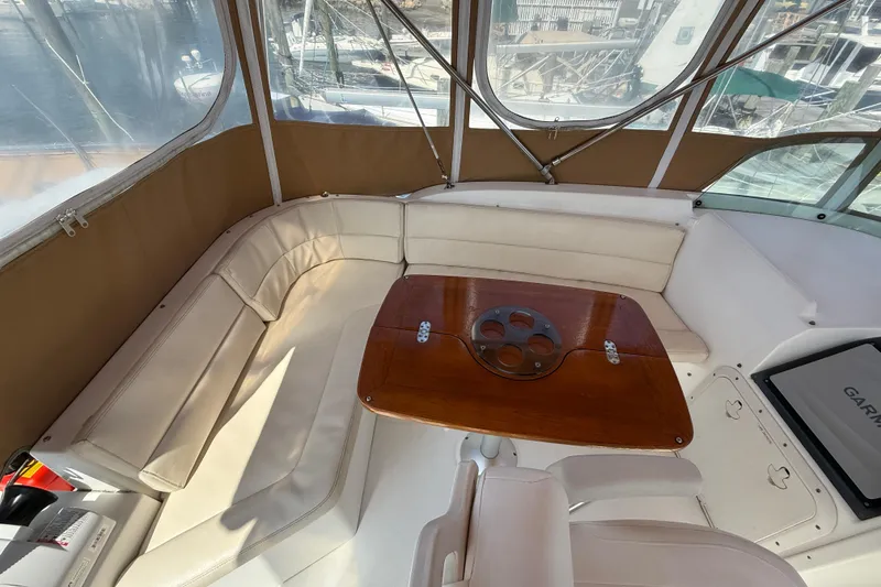 Slide: The Image of 2007 Beneteau Swift Trawler 42 interior with beige seating and wooden table. - 25