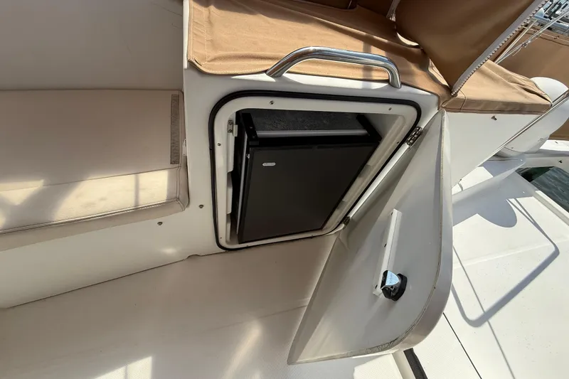 Slide: The Image of 2007 Beneteau Swift Trawler 42 with open storage compartment and beige seating. - 28