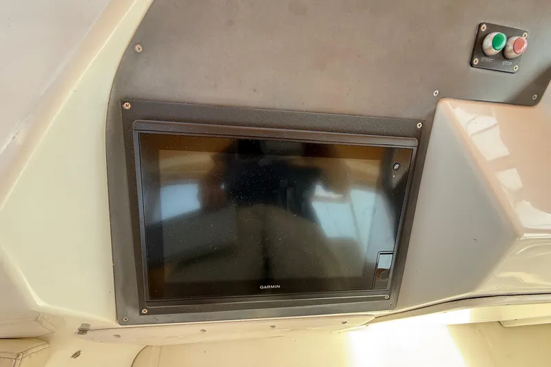 Slide: The Image of Garmin display on 2007 Beneteau Swift Trawler 42 dashboard with start-stop buttons. - 31