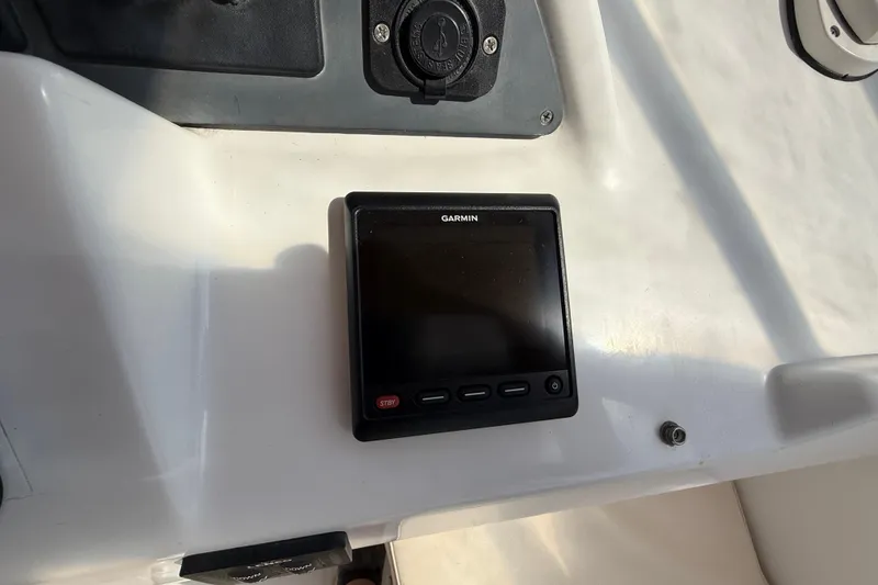 Slide: The Image of Garmin display on 2007 Beneteau Swift Trawler 42 dashboard, featuring control buttons. - 32