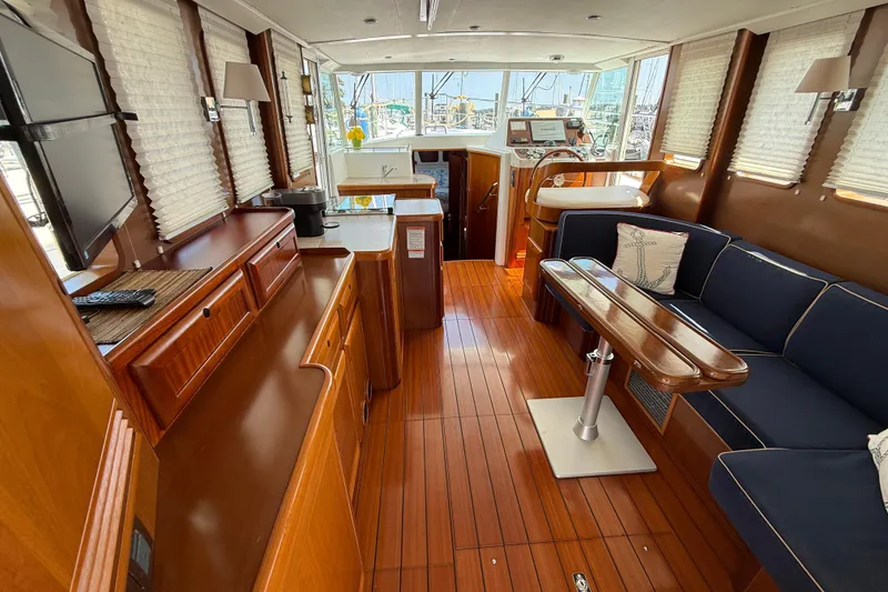 Slide: The Image of Interior of 2007 Beneteau Swift Trawler 42 with wood finish and blue seating. - 34