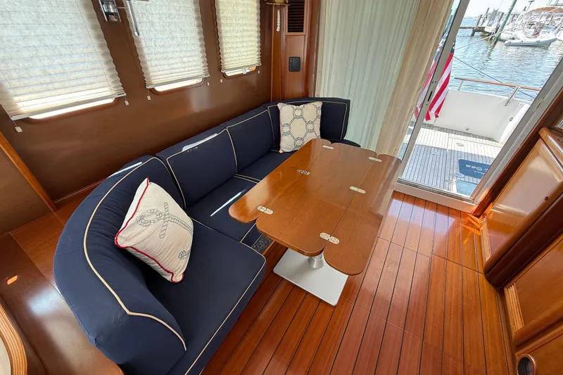 Slide: The Image of Interior of 2007 Beneteau Swift Trawler 42 with wooden flooring and navy seating. - 37