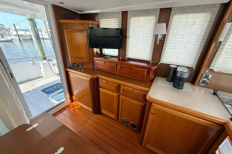 Slide: The Image of Interior of 2007 Beneteau Swift Trawler 42 with wooden cabinetry and modern amenities. - 38