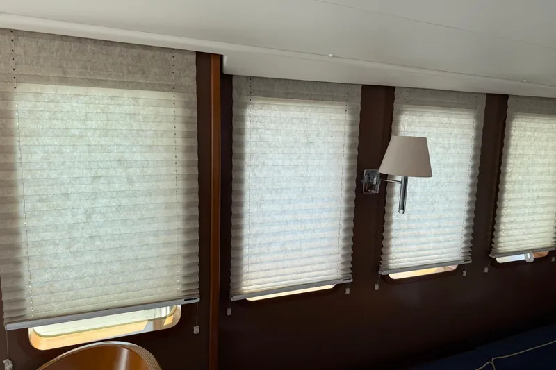 Slide: The Image of Interior of 2007 Beneteau Swift Trawler 42 with window blinds and wall lamp. - 39