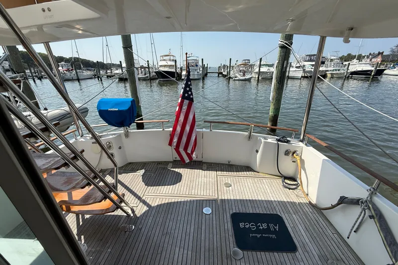 Slide: The Image of 2007 Beneteau Swift Trawler 42 docked, featuring American flag and marina view. - 4