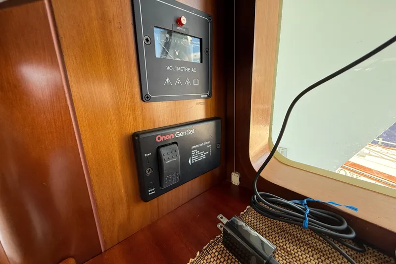 Slide: The Image of Control panel on 2007 Beneteau Swift Trawler 42 with voltmeter and Onan GenSet. - 43