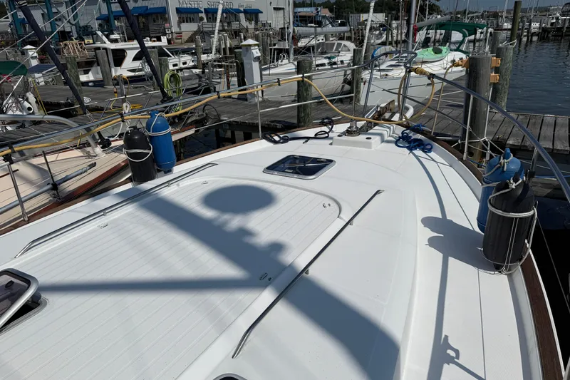 Slide: The Image of 2007 Beneteau Swift Trawler 42 docked at marina, showcasing deck and equipment. - 5