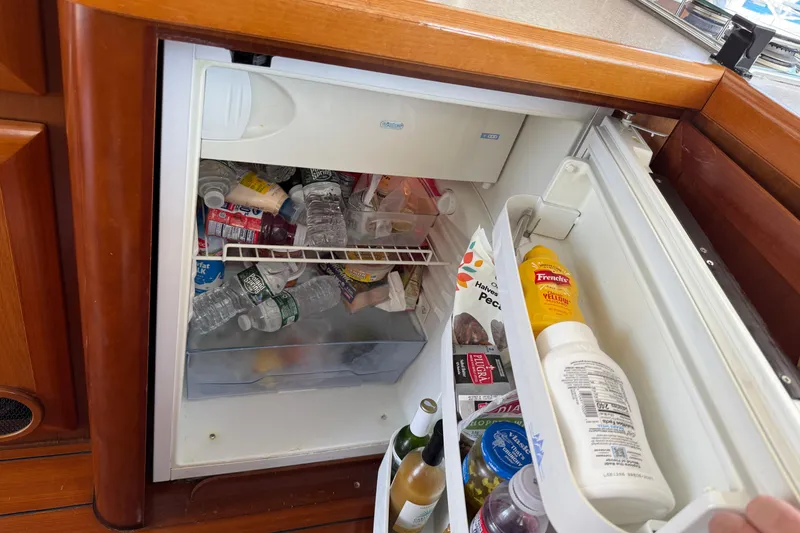 Slide: The Image of Mini fridge stocked with drinks and condiments on a 2007 Beneteau Swift Trawler 42. - 50