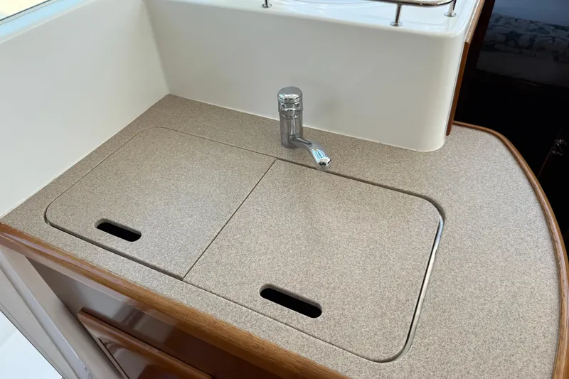 Slide: The Image of 2007 Beneteau Swift Trawler 42 kitchen sink with cover and faucet. - 51