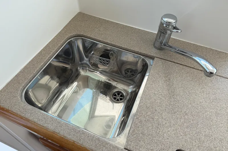 Slide: The Image of Stainless steel sink and faucet in 2007 Beneteau Swift Trawler 42 kitchen area. - 53