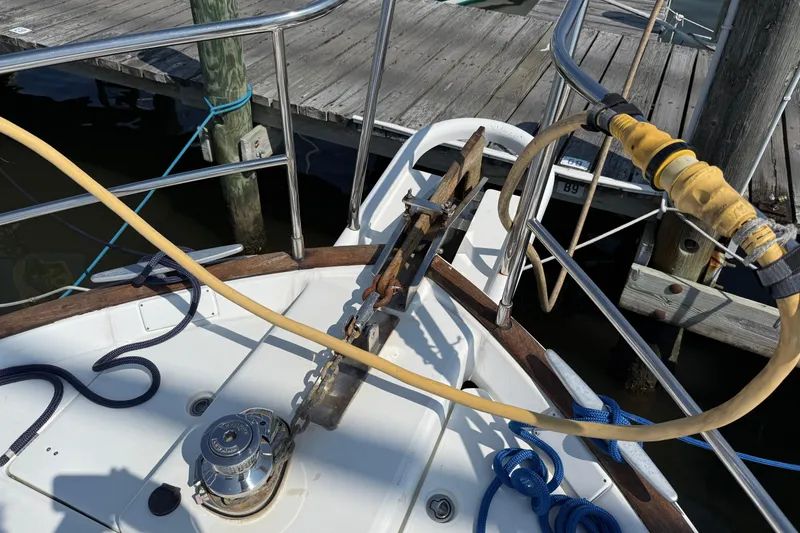 Slide: The Image of 2007 Beneteau Swift Trawler 42 deck with anchor, ropes, and dock view. - 6