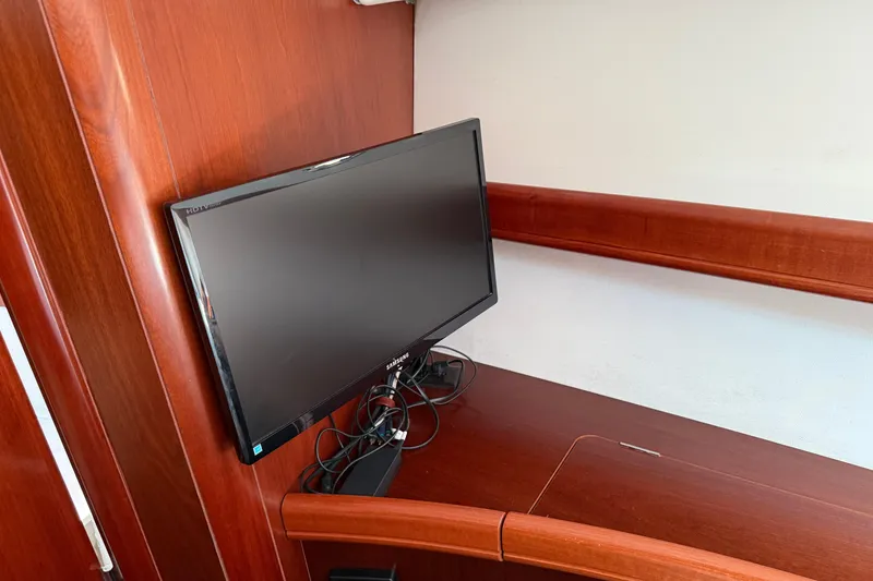 Slide: The Image of Flat-screen TV on 2007 Beneteau Swift Trawler 42, mounted on wooden interior. - 61