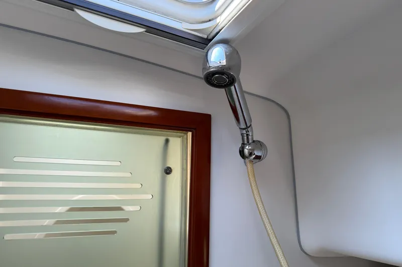 Slide: The Image of Shower area in 2007 Beneteau Swift Trawler 42 with glass door and chrome fixtures. - 62