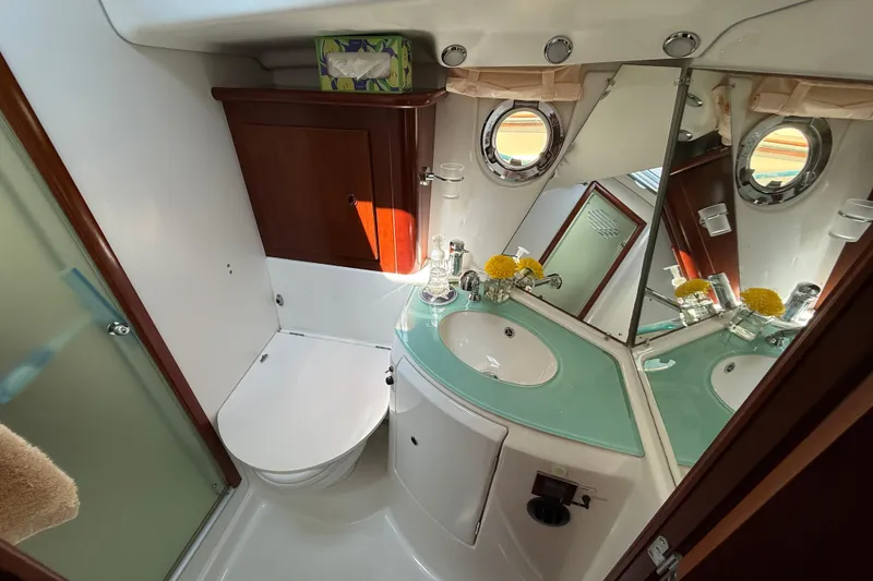 Slide: The Image of Bathroom interior of 2007 Beneteau Swift Trawler 42 with modern fixtures and porthole window. - 63