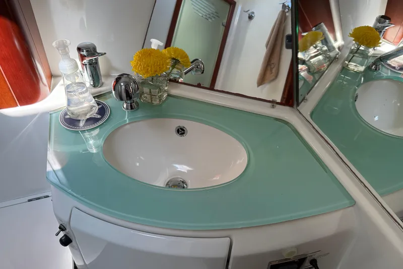 Slide: The Image of Bathroom sink area on 2007 Beneteau Swift Trawler 42 with flowers and soap. - 64