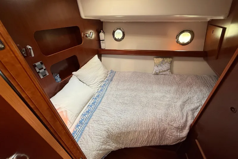 Slide: The Image of Cozy cabin interior of 2007 Beneteau Swift Trawler 42 with portholes and comfortable bedding. - 67