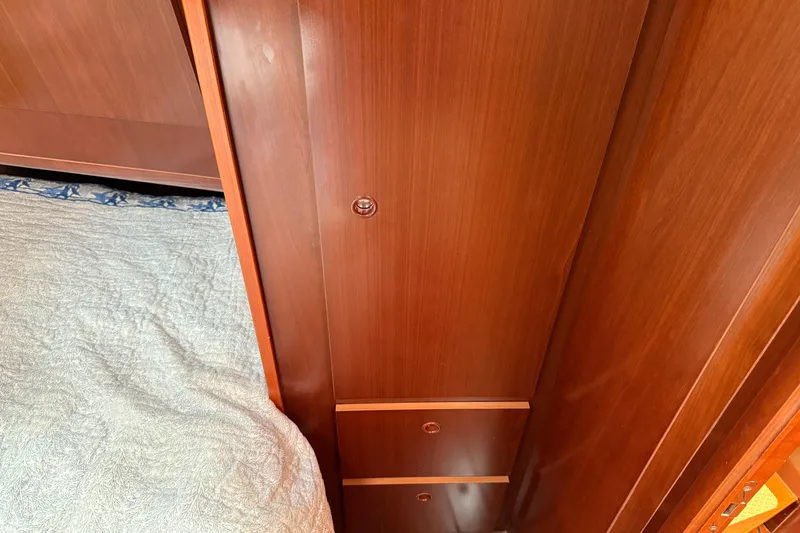 Slide: The Image of Wooden interior of 2007 Beneteau Swift Trawler 42, featuring a bed and storage. - 69