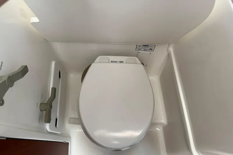 Slide: The Image of 2007 Beneteau Swift Trawler 42 bathroom with white marine toilet. - 74
