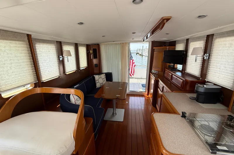 Slide: The Image of Interior of 2007 Beneteau Swift Trawler 42 with elegant wood finish and cozy seating. - 78