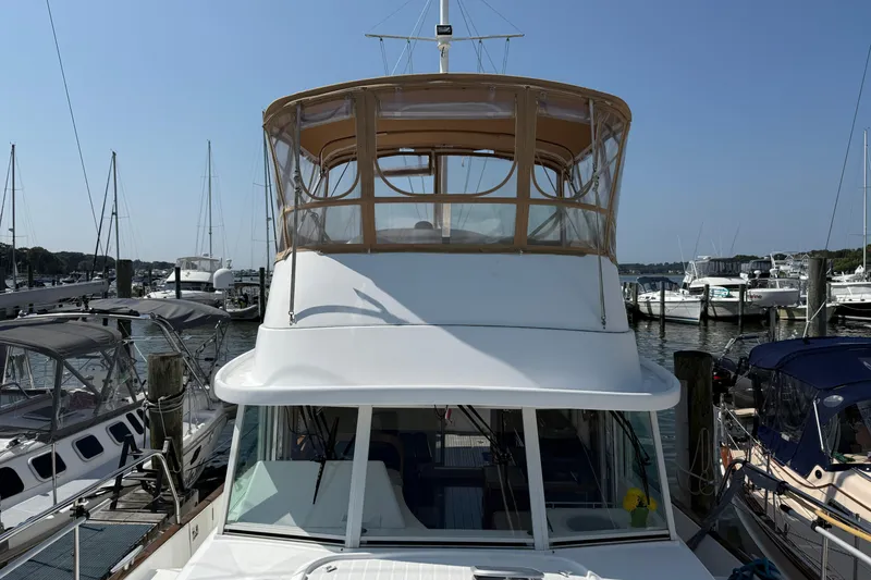 Slide: The Image of 2007 Beneteau Swift Trawler 42 docked at marina, clear sky background. - 8