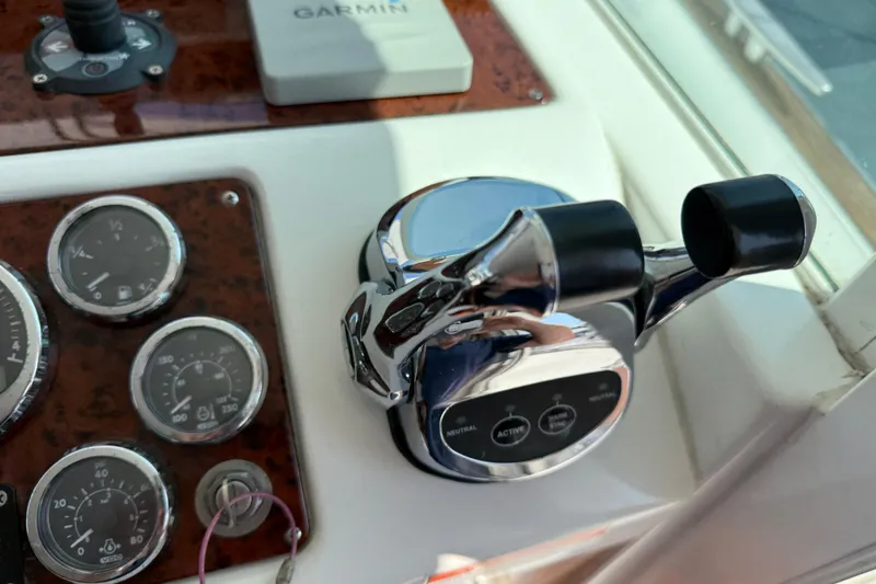 Slide: The Image of Control panel of a 2007 Beneteau Swift Trawler 42 with gauges and throttle levers. - 85