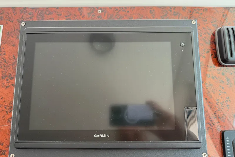 Slide: The Image of Garmin display on 2007 Beneteau Swift Trawler 42 dashboard with wood paneling. - 87