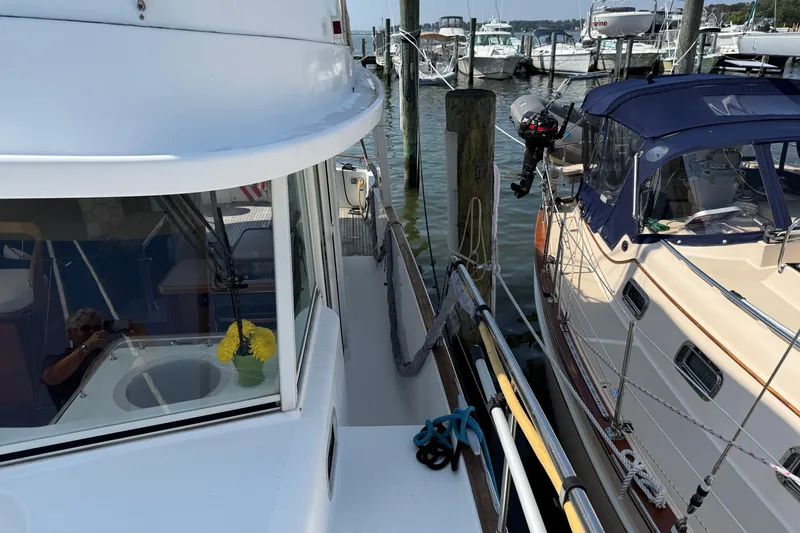 Slide: The Image of 2007 Beneteau Swift Trawler 42 docked beside another boat in a marina. - 9