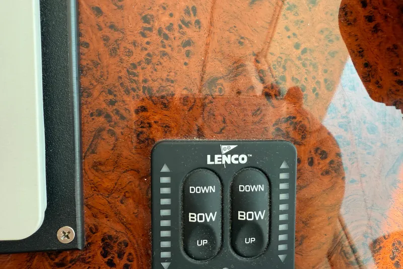 Slide: The Image of Lenco control panel on 2007 Beneteau Swift Trawler 42 with wood grain background. - 90