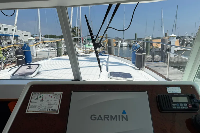 Slide: The Image of 2007 Beneteau Swift Trawler 42 helm with Garmin navigation, docked at marina. - 91