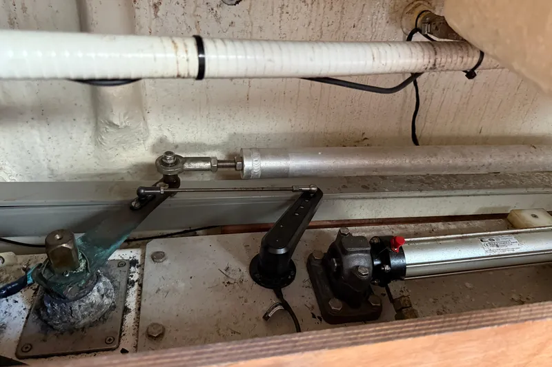 Slide: The Image of Engine compartment of 2007 Beneteau Swift Trawler 42, showcasing mechanical components and piping. - 94