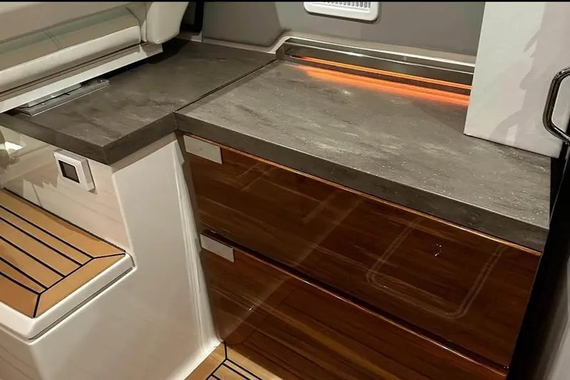 Slide: The Image of 2023 Tiara Yachts 43 LS interior with sleek countertops and wooden cabinetry. - 23