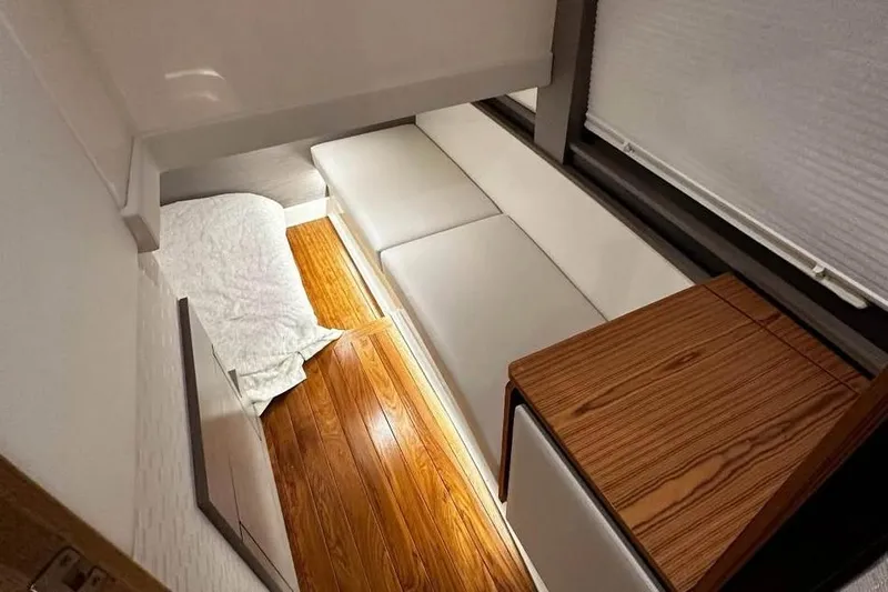 Slide: The Image of 2023 Tiara Yachts 43 LS interior with wooden flooring and white seating. - 25