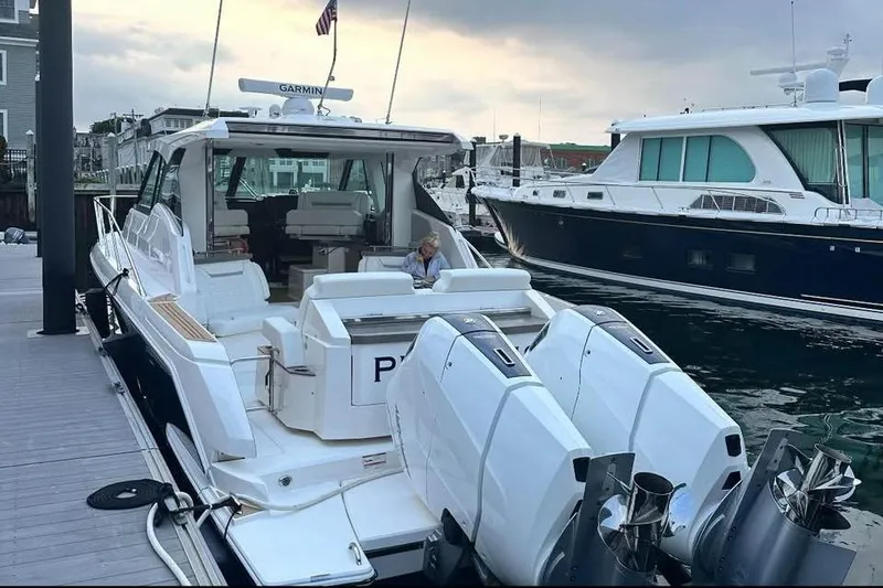 Slide: The Image of 2023 Tiara Yachts 43 LS docked, featuring dual outboard engines and spacious seating. - 5