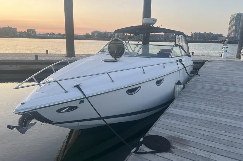 The Image of White 2008 Cobalt 323 boat docked at sunset, calm water, urban skyline background. - 0
