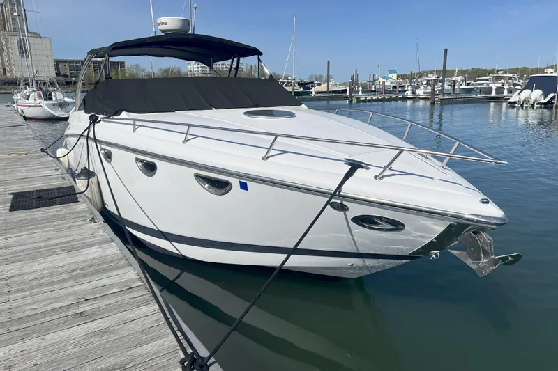 Slide: The Image of 2008 Cobalt 323 boat docked at marina, clear sky, calm water. - 1