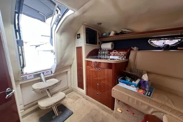 Slide: The Image of Interior of a 2008 Cobalt 323 boat with cozy seating and kitchenette. - 11
