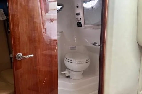 Slide: The Image of 2008 Cobalt 323 boat interior bathroom with wooden door and modern fixtures. - 13