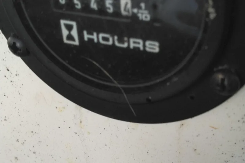 Slide: The Image of Close-up of a 2008 Cobalt 323 hour meter gauge displaying usage hours. - 18
