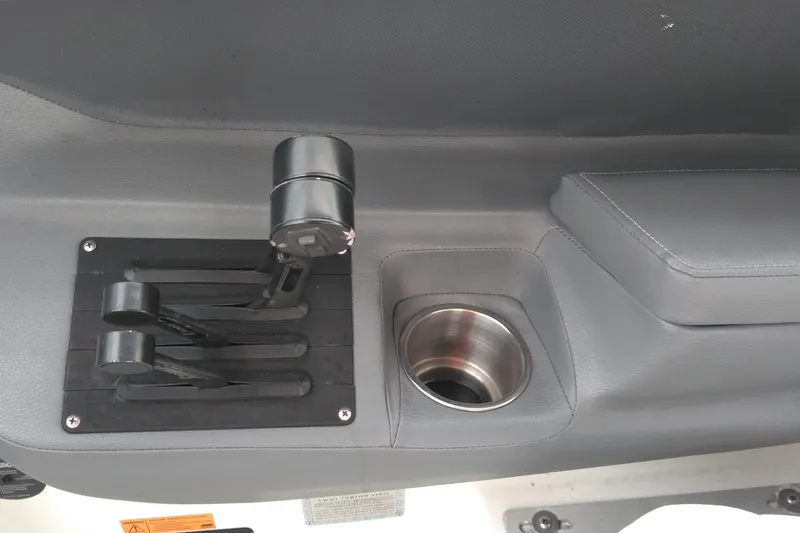 Slide: The Image of 2008 Cobalt 323 boat controls and cup holder on gray interior panel. - 21