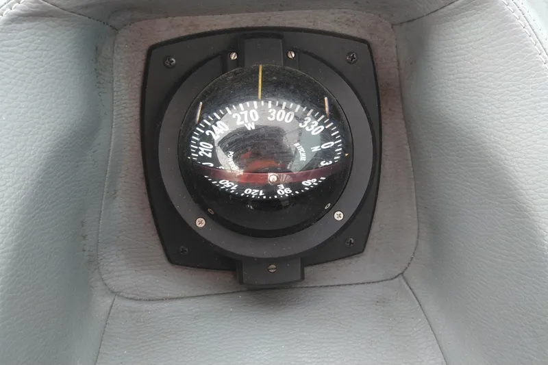 Slide: The Image of Compass on 2008 Cobalt 323 boat dashboard, surrounded by gray upholstery. - 22