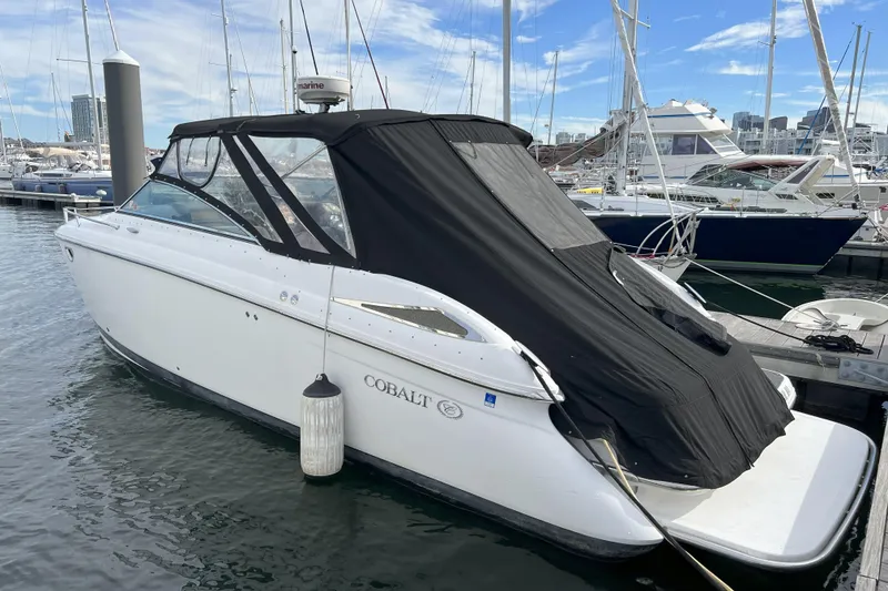 Slide: The Image of 2008 Cobalt 323 boat docked in marina, covered with black canopy. - 5