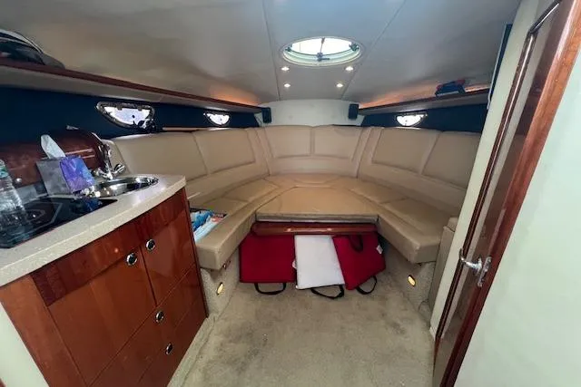 Slide: The Image of Interior of a 2008 Cobalt 323 boat with beige seating and wooden cabinetry. - 9