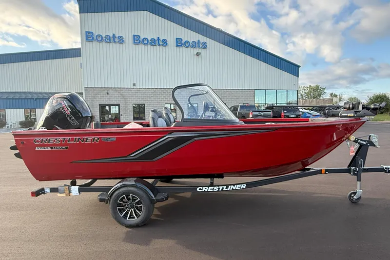 The Image of Red 2026 Crestliner 1750 HAWK WT boat on trailer, parked outside dealership. - 0