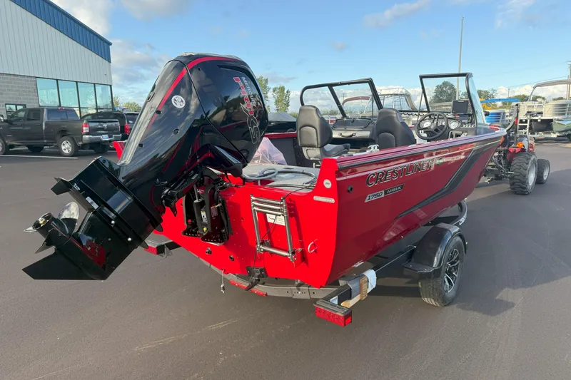 Slide: The Image of 2026 Crestliner 1750 HAWK WT boat with powerful outboard motor, parked outdoors. - 2
