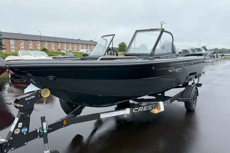 Slide: The Image of 2026 Crestliner 1950 Sportfish boat on trailer, parked on wet pavement. - 1