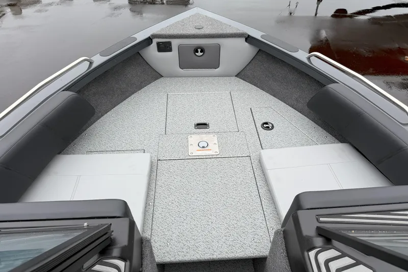 Slide: The Image of 2026 Crestliner 1950 Sportfish boat interior with gray seating and storage compartments. - 10